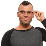 Man wearing glasses and a gray long-sleeve shirt smiling