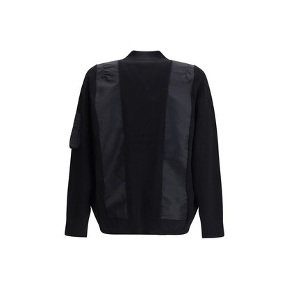 Back view of Sacai Black Cotton Bomber featuring paneled design, double-slider zipper, and ribbed trims, showcasing elegant functionality.