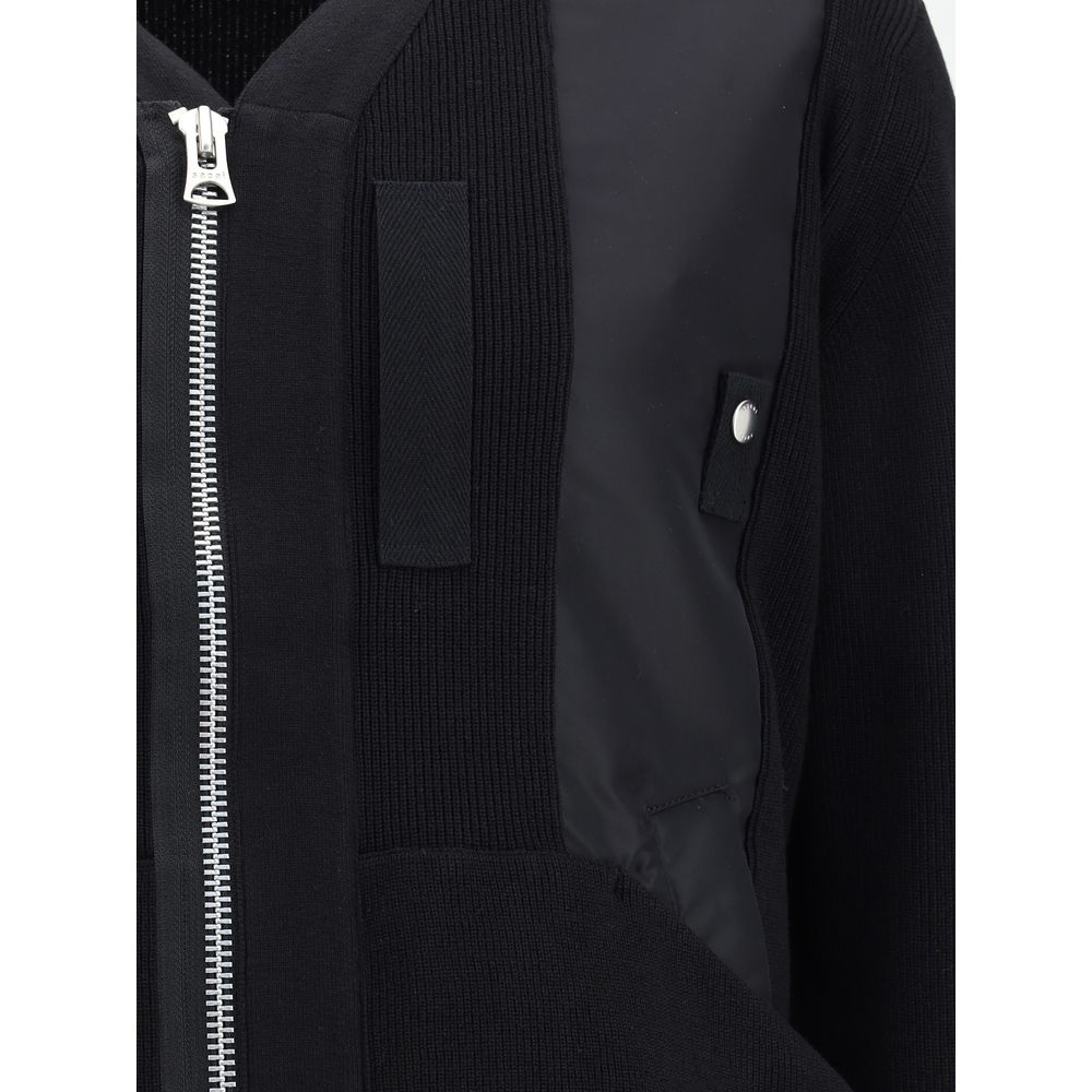 Close-up of Sacai Black Cotton Bomber with double-slider zipper and ribbed trim, showcasing contemporary style and functionality.