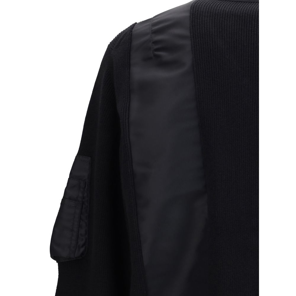 Close-up of Sacai Black Cotton Bomber showcasing paneled design and ribbed trim highlights.