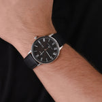 TIMEX Mod. WATERBURY CLASSIC wristwatch on wrist, stainless steel case, black leather strap, mineral dial, quartz movement, 5 ATM water resistant.