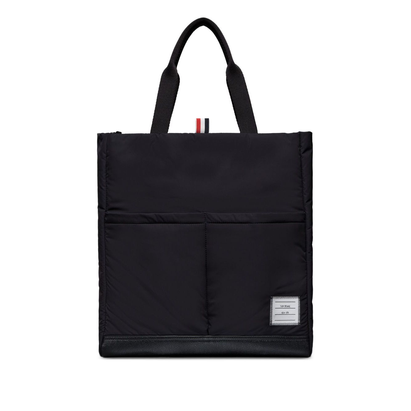 Thom Browne Multi pocket tote bag in black with two top handles, front patch pockets, and internal zip pocket, comes with dust bag.