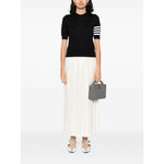 Woman wearing a Thom Browne Sweaters Blue navy blue crew neck with short sleeves, featuring signature grosgrain loop tab and 4Bar details.