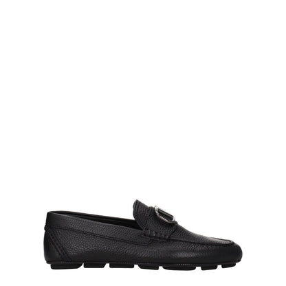 Valentino Garavani Black Leather Slip-On Loafers with front logo, silver details, rubber sole, round toe, low flat heel.