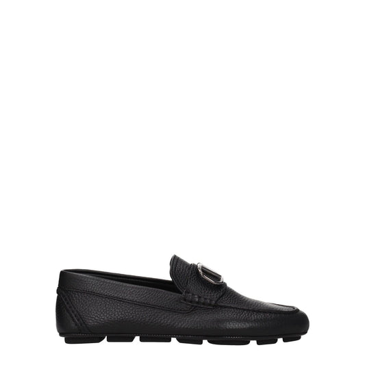 Valentino Garavani Black Leather Slip-On Loafers with front logo, silver details, rubber sole, round toe, low flat heel.