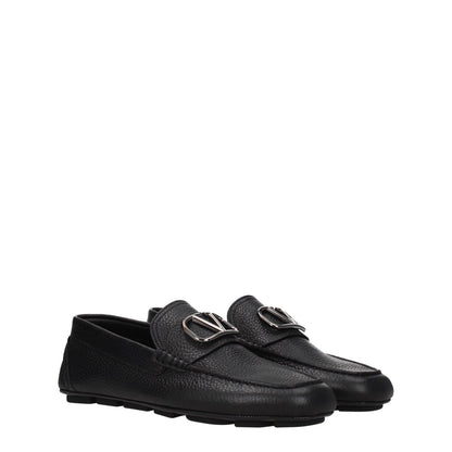 Valentino Garavani Black Leather Slip-On Loafers with round toe, rubber sole, and silver logo detail, low flat heel.