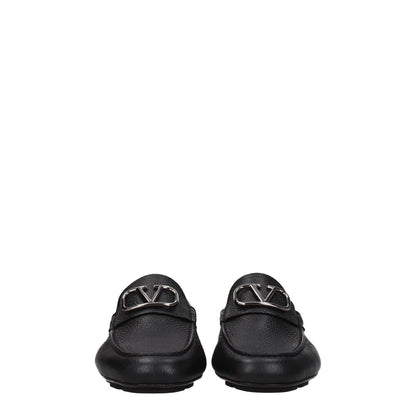 Valentino Garavani Black Leather Slip-On Loafers with silver front logo and round toe, stylish design with rubber sole.