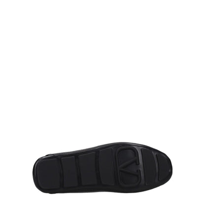 Valentino Garavani Black Leather Slip-On Loafers rubber sole view, featuring stylish design and front logo detail.