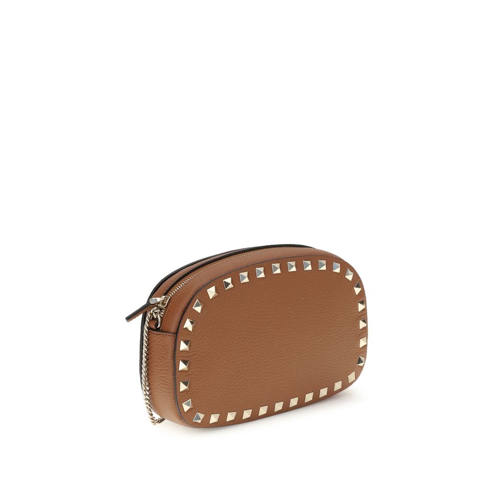 Valentino Garavani Brown Calf Leather Bos Taurus Shoulder Bag with platinum-finish studs and adjustable chain for cross-body wear.