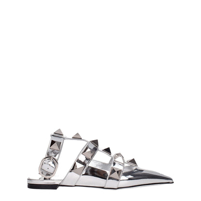 Valentino Garavani Gray Leather Flat Sandals with silver patent leather and studs, featuring a buckle closure and pointy toe design.