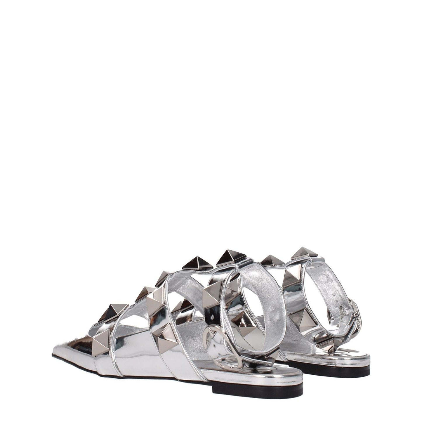 Valentino Garavani Gray Leather Flat Sandals in silver patent leather with studs and buckle closure, featuring a low flat heel.