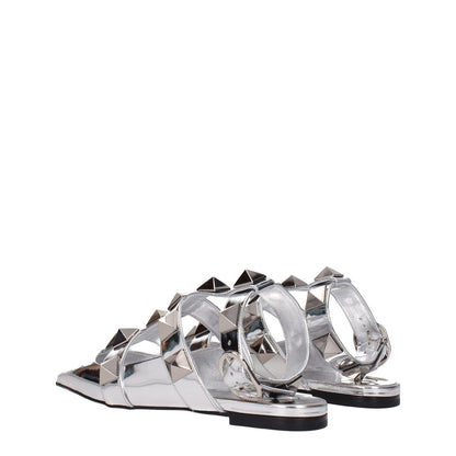Valentino Garavani Gray Leather Flat Sandals in silver patent leather with studs and buckle closure, featuring a low flat heel.
