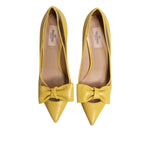 Valentino Yellow Patent Leather PVC Bow Heels Pumps Shoes with pointed toes and bow detail, top view of shoes showing design and craftsmanship.