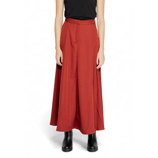 Model wearing Vero Moda Red Polyester Long Skirt with high waist and flared design, featuring side pockets and concealed front closure.