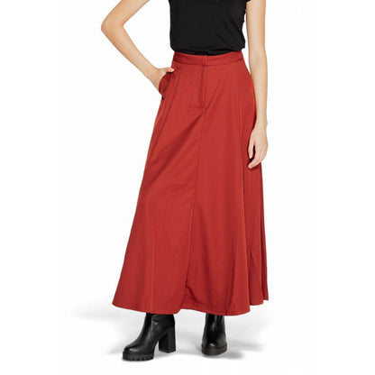 Woman wearing Vero Moda Red Polyester Long Skirt, featuring a high waist and flared design with side pockets, perfect for any occasion.
