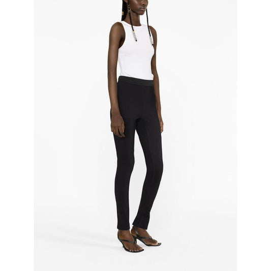 Model wearing WARDROBE.NYC Trousers Black with elasticated waist and rear slit, high waist stretch-design leggings.