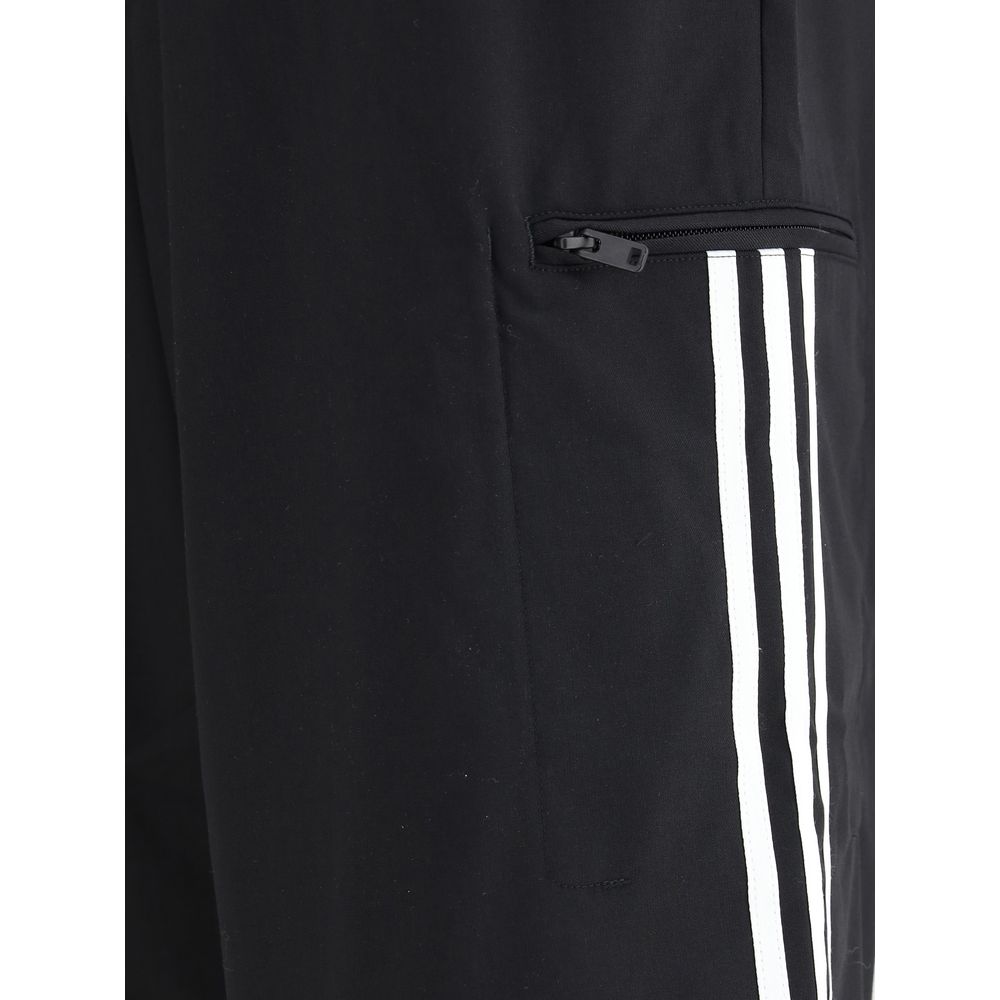 Close-up of Y-3 Black Wool Casual Pants with zipper pocket and white stripes.