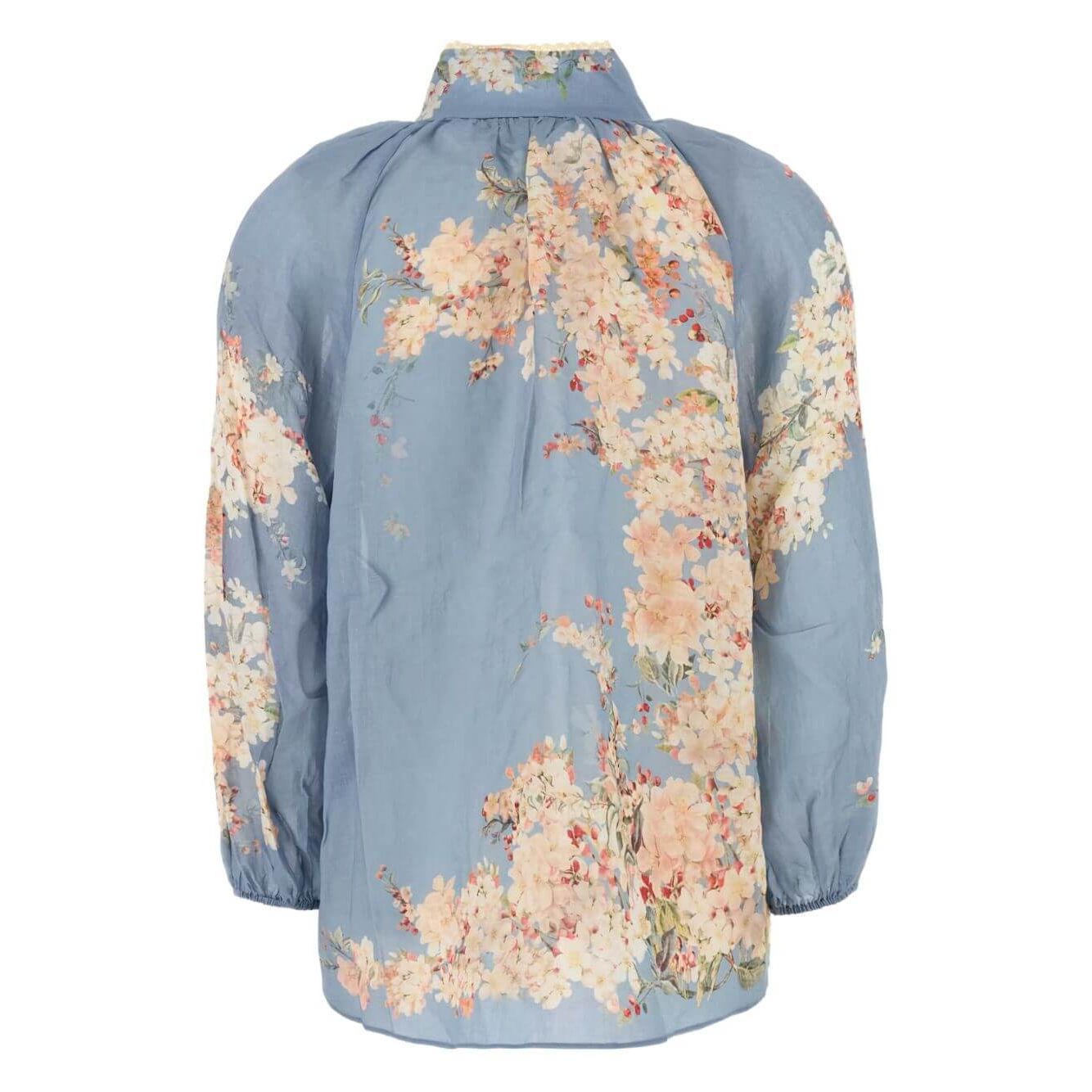 Zimmermann Cascadian Billow Blouse in light blue floral print with long sleeves and mock neck, back view.
